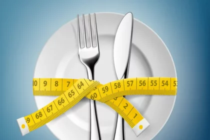 Plate and utenstils with measuring tape wrapped around - Habits To Start Your Weight Loss Journey