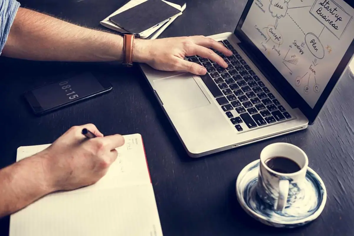 Man working on laptop with coffee
