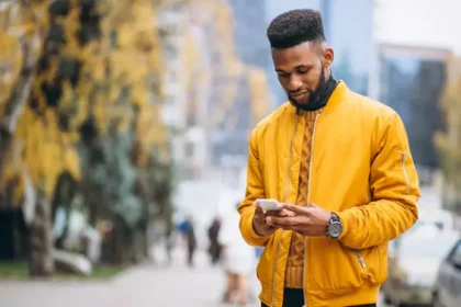 african-american-student-walking-street-talking-phone