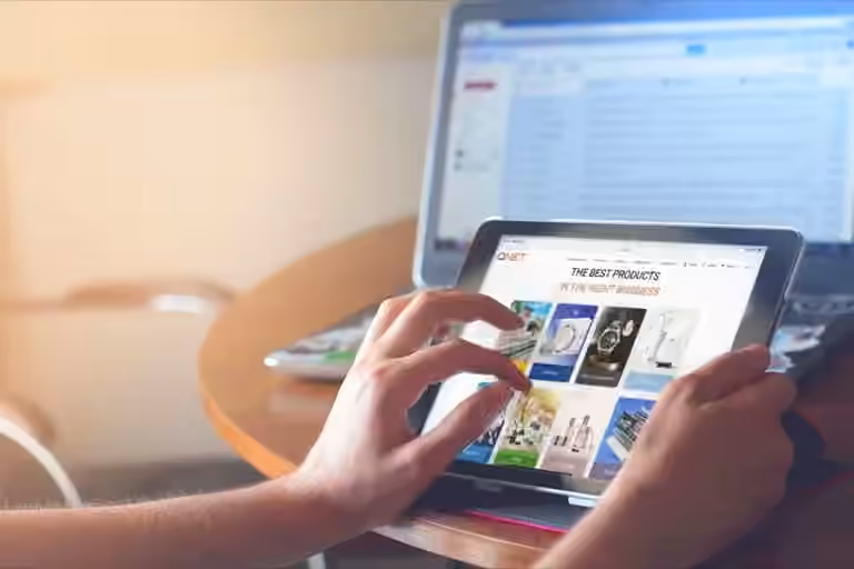 Looking at QNET site on tablet in front of a computer