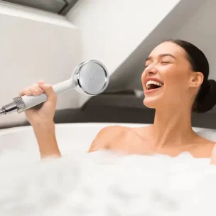 Lady singing in the bathtub, HomePure Rayn in hand.