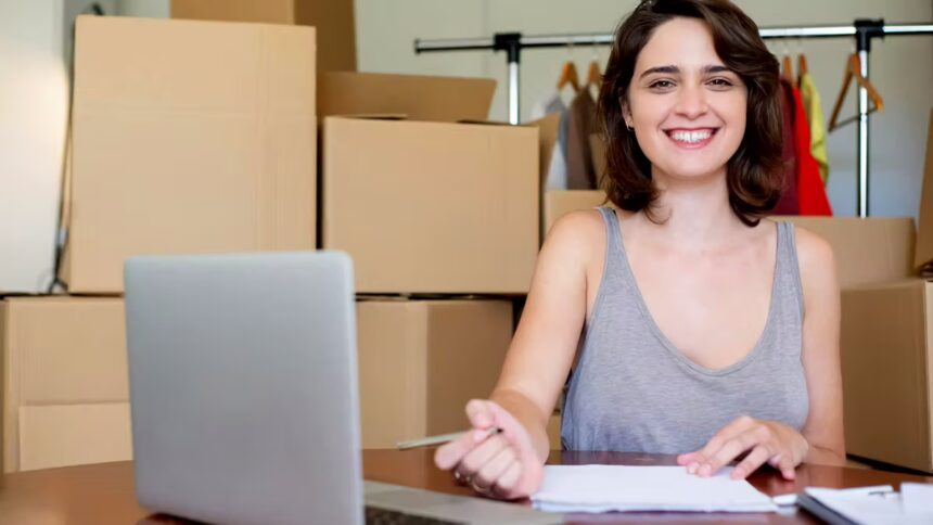 Girl smiling in front of boxes for her micro, small and medium-sized enterprise