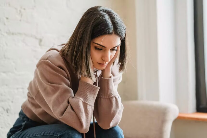 Sad woman wondering is the middle class the new poor?